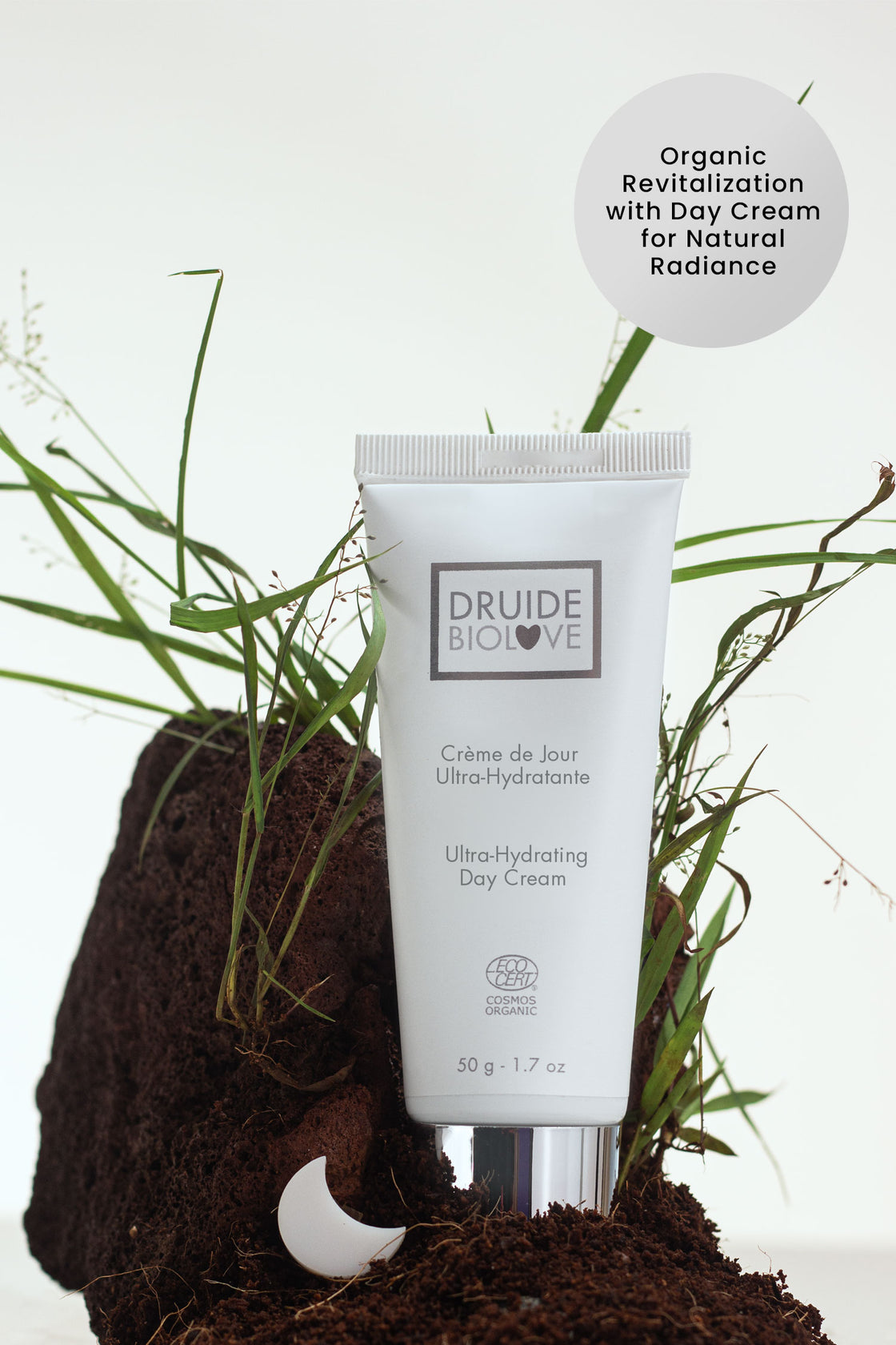 Druide Biolove Organic Ultra-Hydrating Day Cream shown on fresh soil and grass with text reading "organic revitalisation with day cream for natural radiance".
