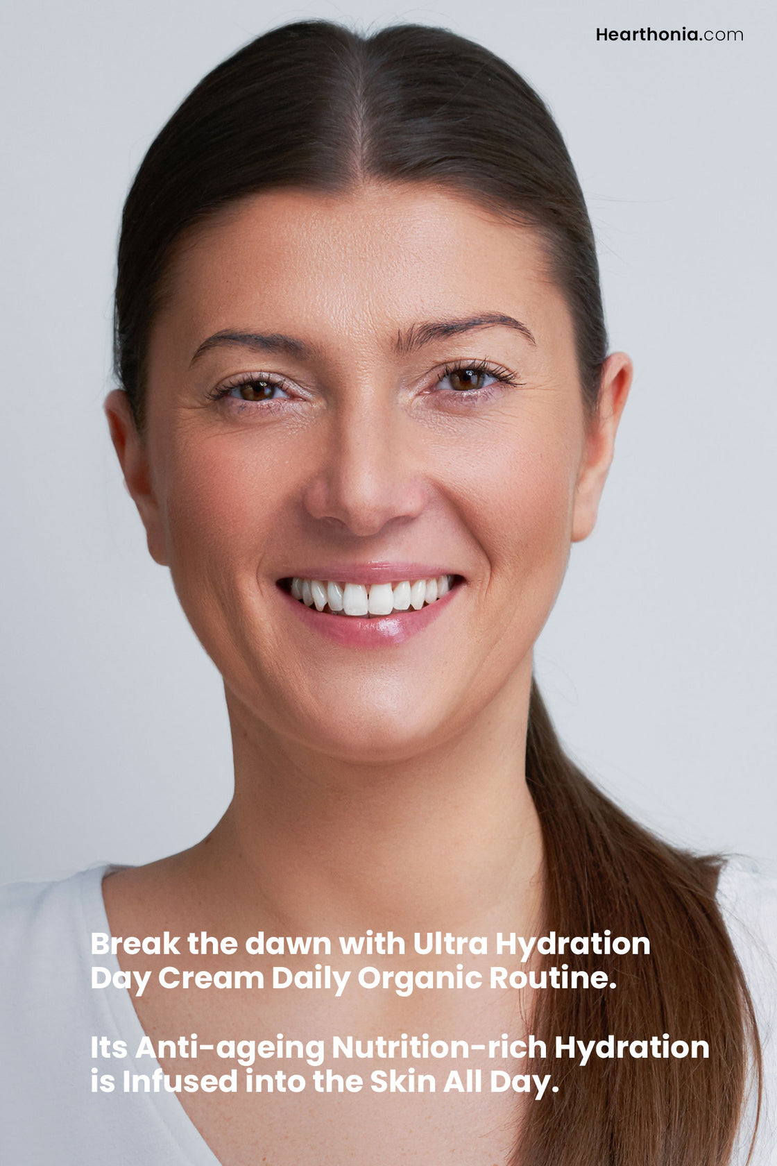 Smiling woman showcasing radiant skin with text stating "break the dawn with ultra hydration day cream daily organic routine".