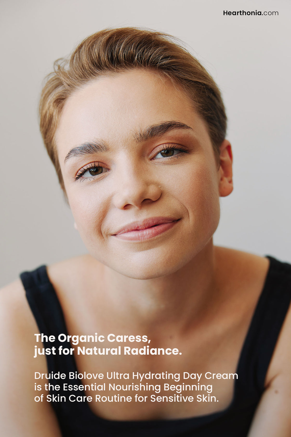 Happy woman showcasing gazing into the camera with text reading "the organic caress, just for natural radiance".