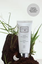 Druide Biolove Organic Nightly Ultra Nourishing Cream tube shown on natural soil and grass with text