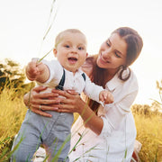 Happy mum and baby in a british field on a sunny day