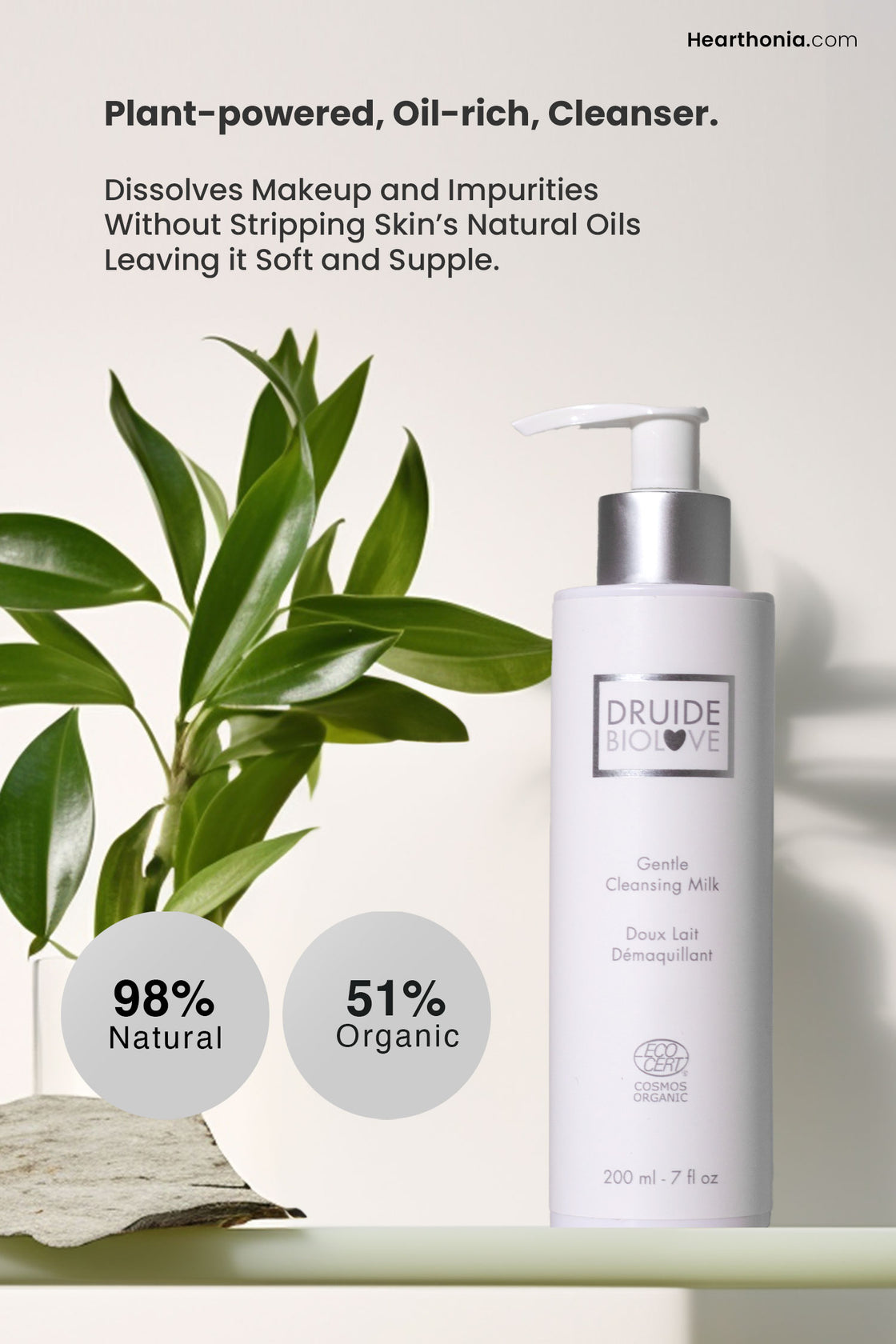 White pump dispenser of Druide Biolove Organic Gentle Cleansing Milk on a shelf with indoor plant. Text reads "98% natural and 51% organic", dissolves makeup and impurities without stripping skin's natural oils leaving it soft and supple".