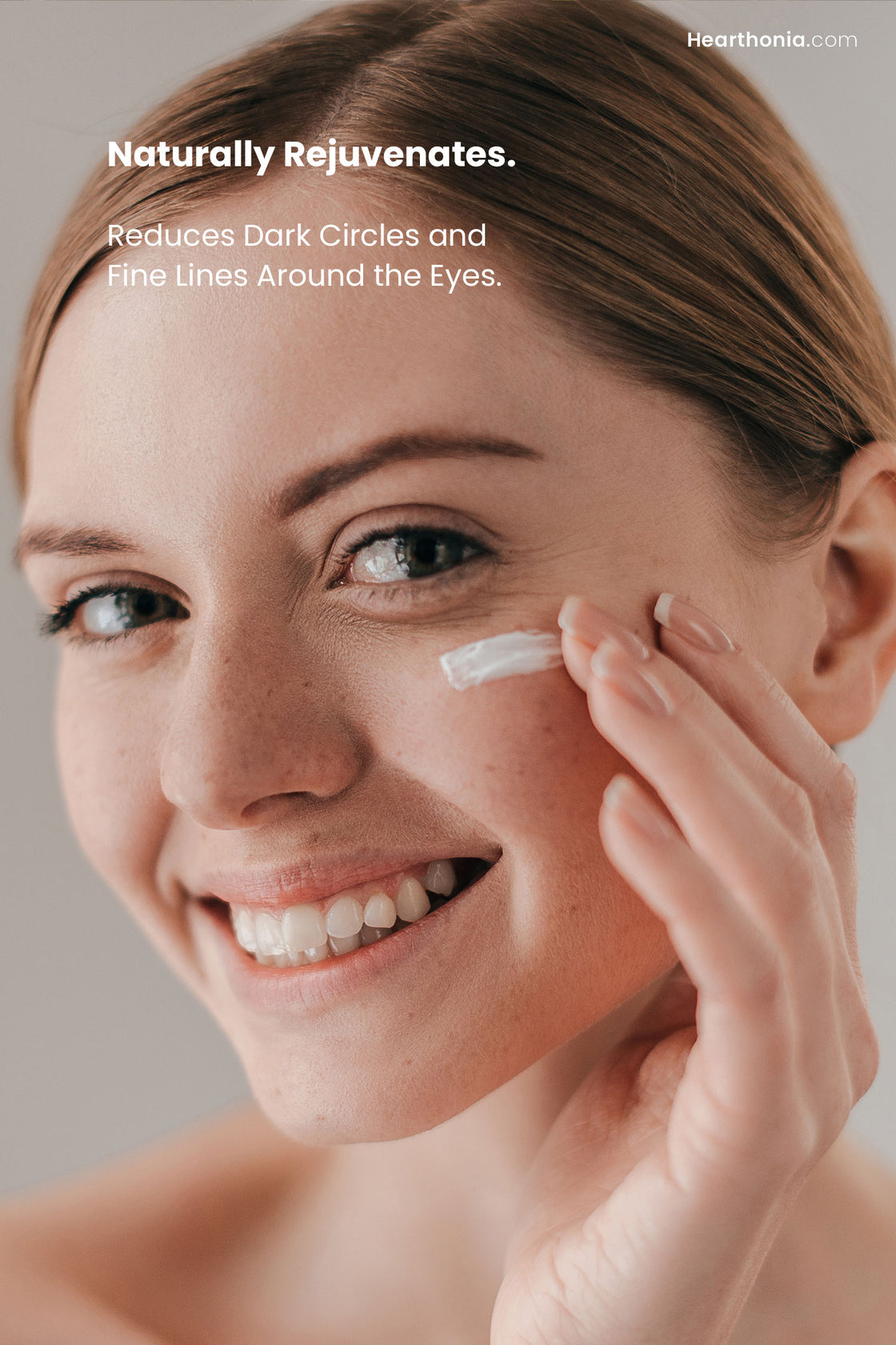 Smiling woman applying Druide Biolove Organic Eye Contour Cream under the eye, with text reading "naturally rejuvenates, reduces dark circles and fine lines around the eyes".