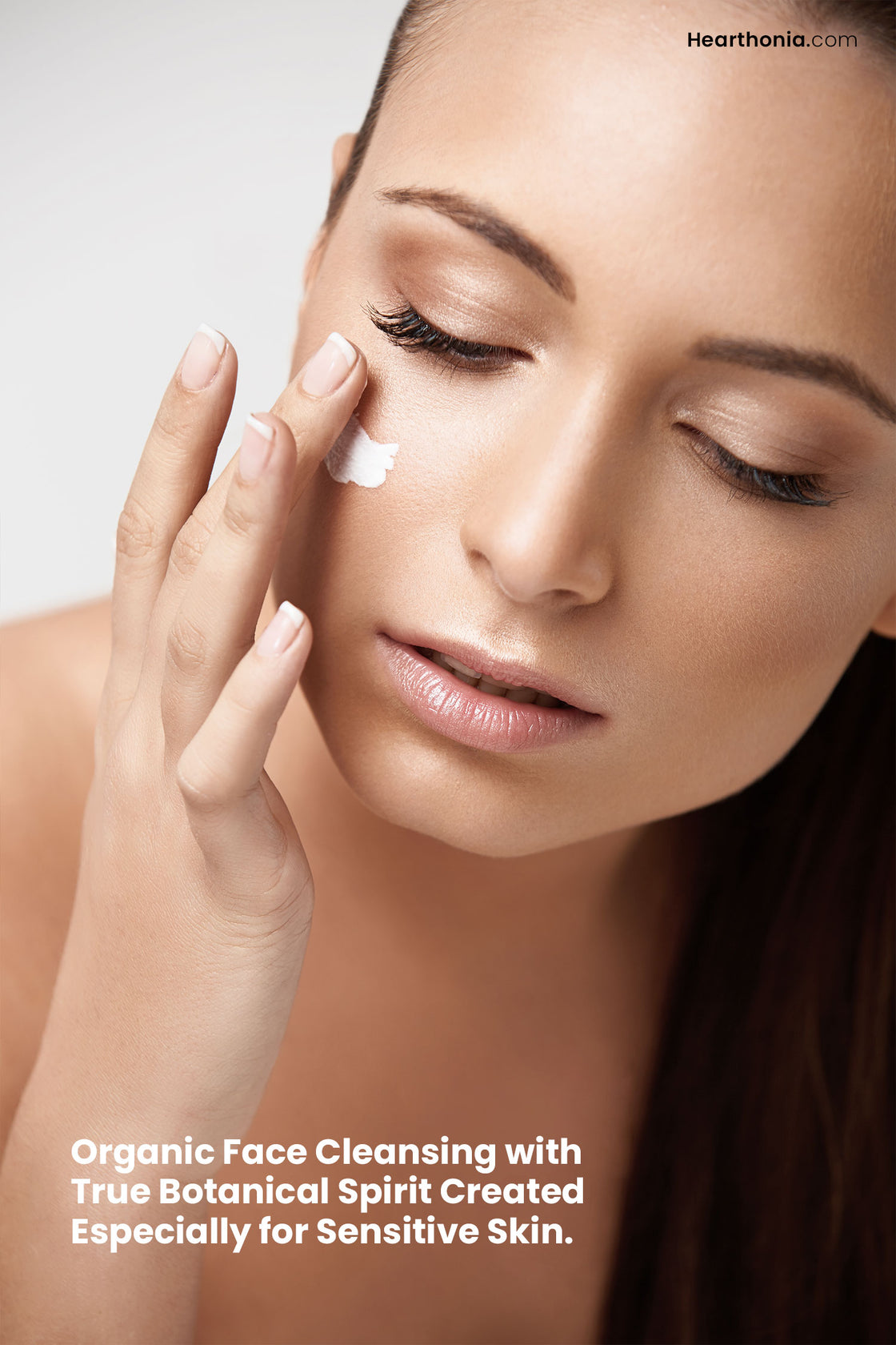 Modern woman applying a dab of Druide Biolove Organic Gentle Cleansing Milk on her cheek with text stating "organic face cleansing with true botanical spirit created especially for sensitive skin".
