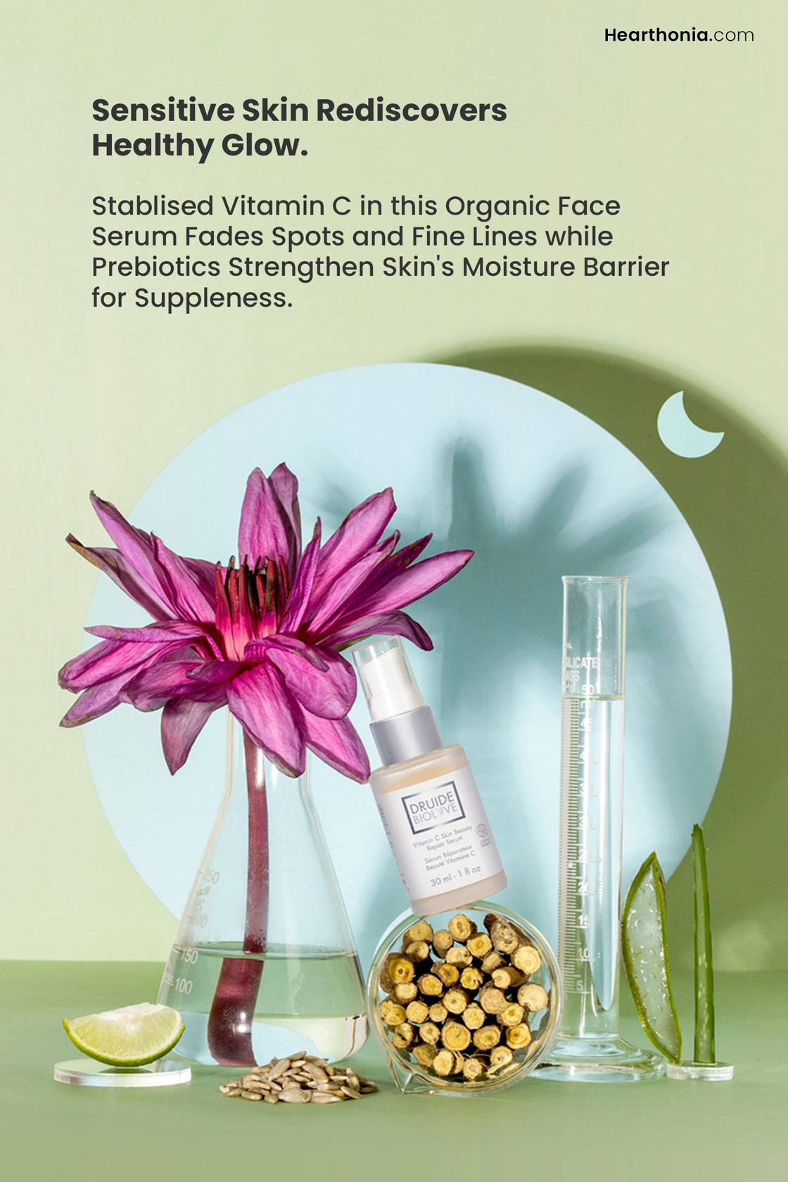 Druide Biolove Organic Vitamin C  Serum  pump glass bottle surrounded by pure ingredients like lime, seeds, roots, aloe vera and a beautiful pink Lotus flower, and text stating ""Sensitive skin rediscovers healthy glow".
