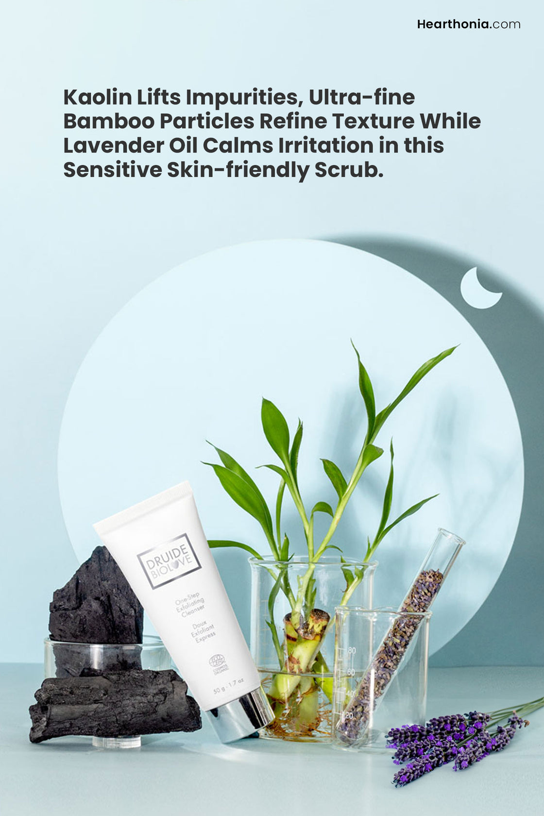 White tube of Druide Biolove Organic Exfoliating Cleanser amidst fresh ingredients like bamboo root, lavender sprigs.