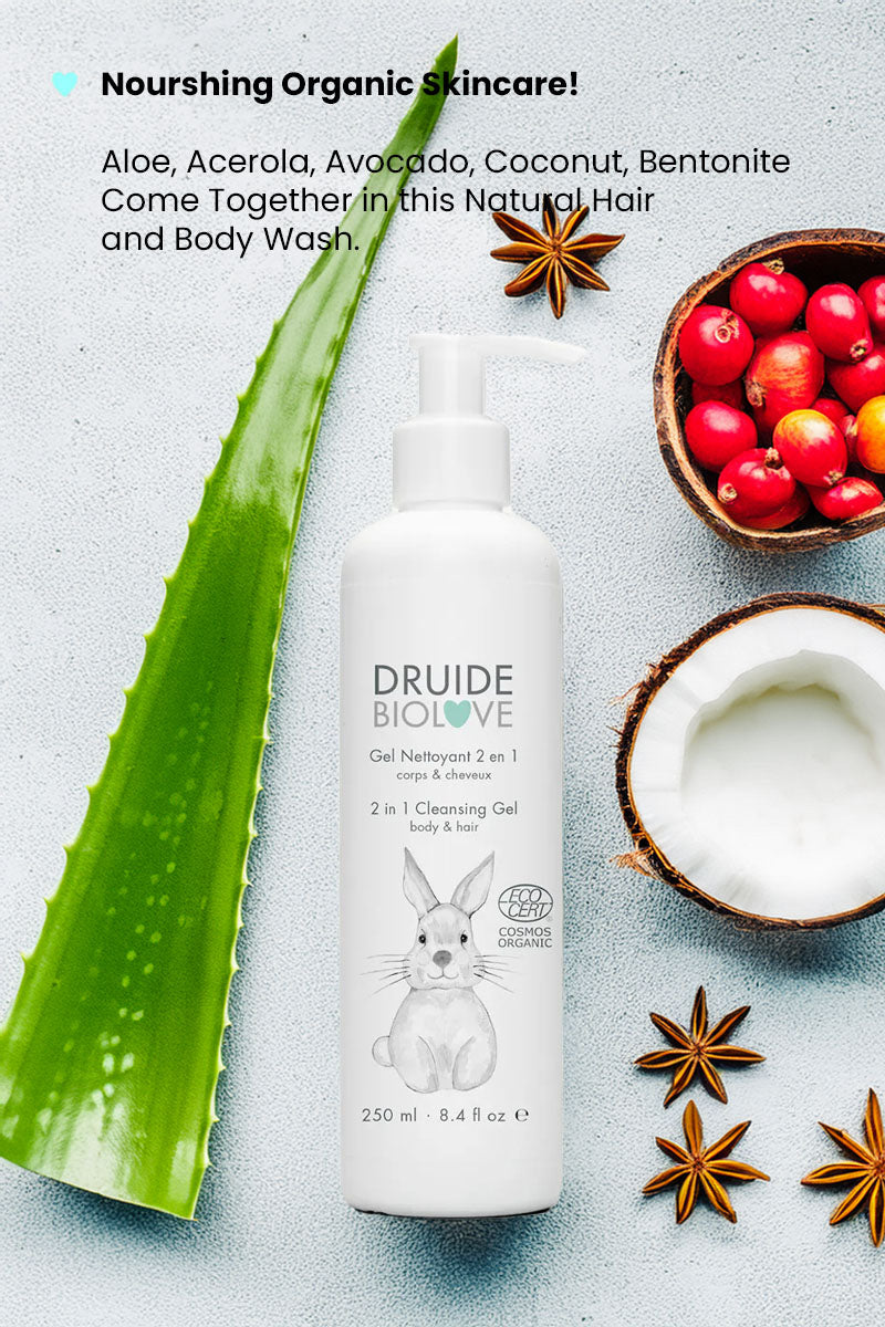 Druide Biolove Organic 2in1 cleansing gel baby body wash and shampoo dispenser amidst fresh ingredients including aloe vera stem, star anise, acerola cherries, and cracked coconut, with text reading "nourishing organic skincare".