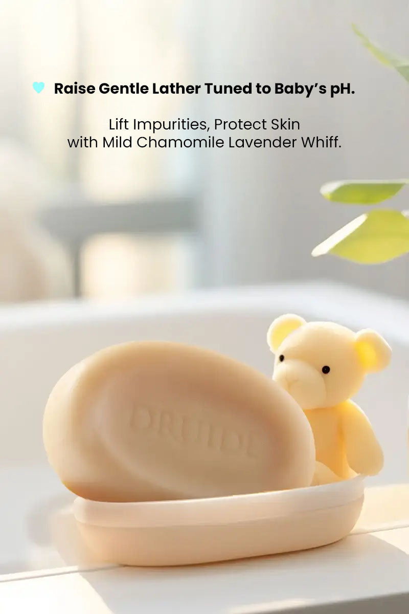 Druide Biolove Protective Soap Bar Sensitive Skin in a soap dish with a mini teddy bear, text reading "raise gentle lather tuned to baby's pH".

