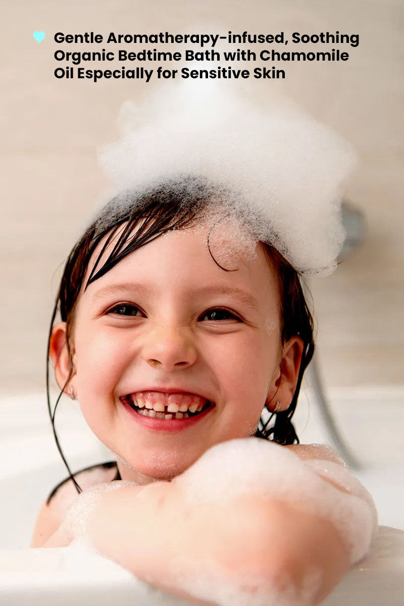 young girl in a bath, wrapped in rich lather and foam with text reading "gentle aromatherapy-infused soothing organic bedtime bath with chamomile oil especially for sensitive skin".