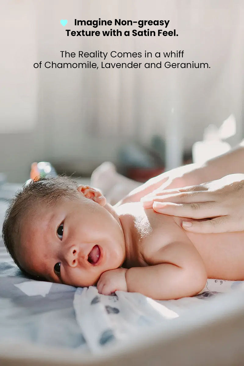 Baby lying on chest with mum massaging the back and text reading "imagine non greasy texture with a satin feel, the reality comes in a whiff of chamomile, lavender and geranium".