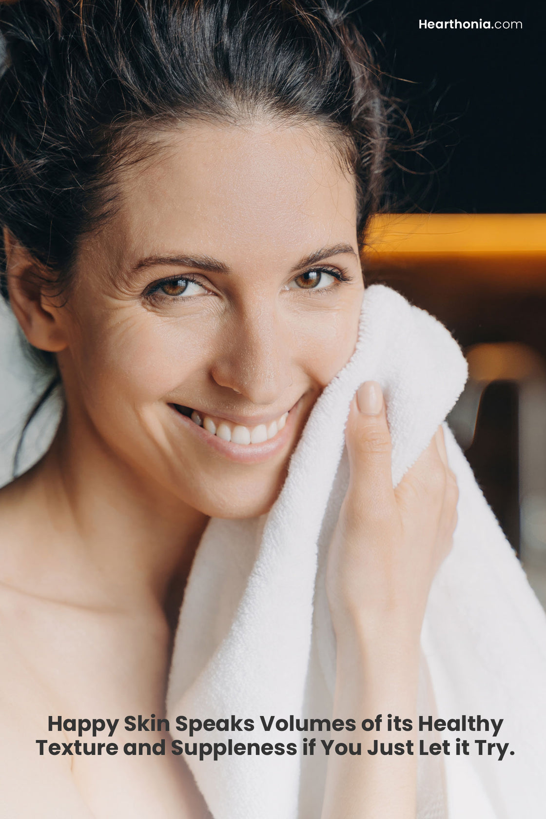 A smiling woman wiping her face with text reading "happy skin speaks volumes of its healthy texture and suppleness if you just let it try".