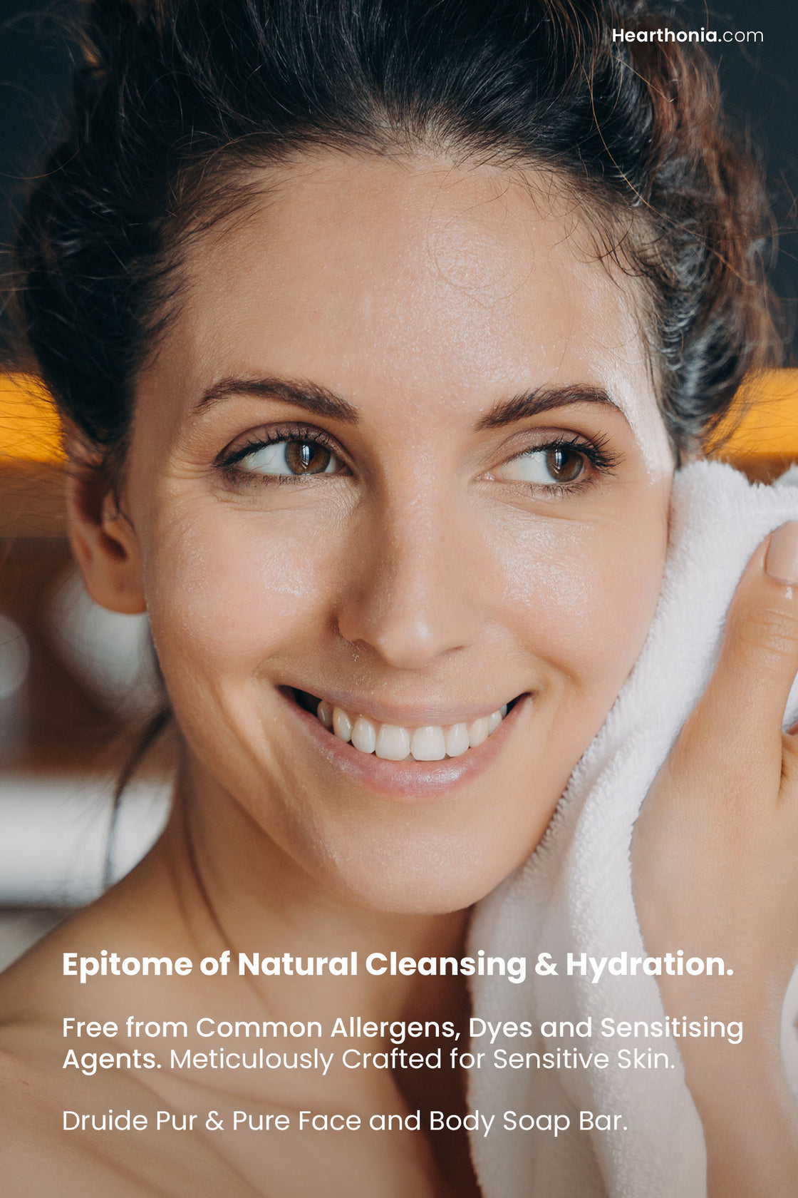 smiling woman wiping face after wash with text reading "epitome of natural cleansing and hydration, free from common allergens, dyes and sensitising agents, meticulously crafted for sensitive skin".