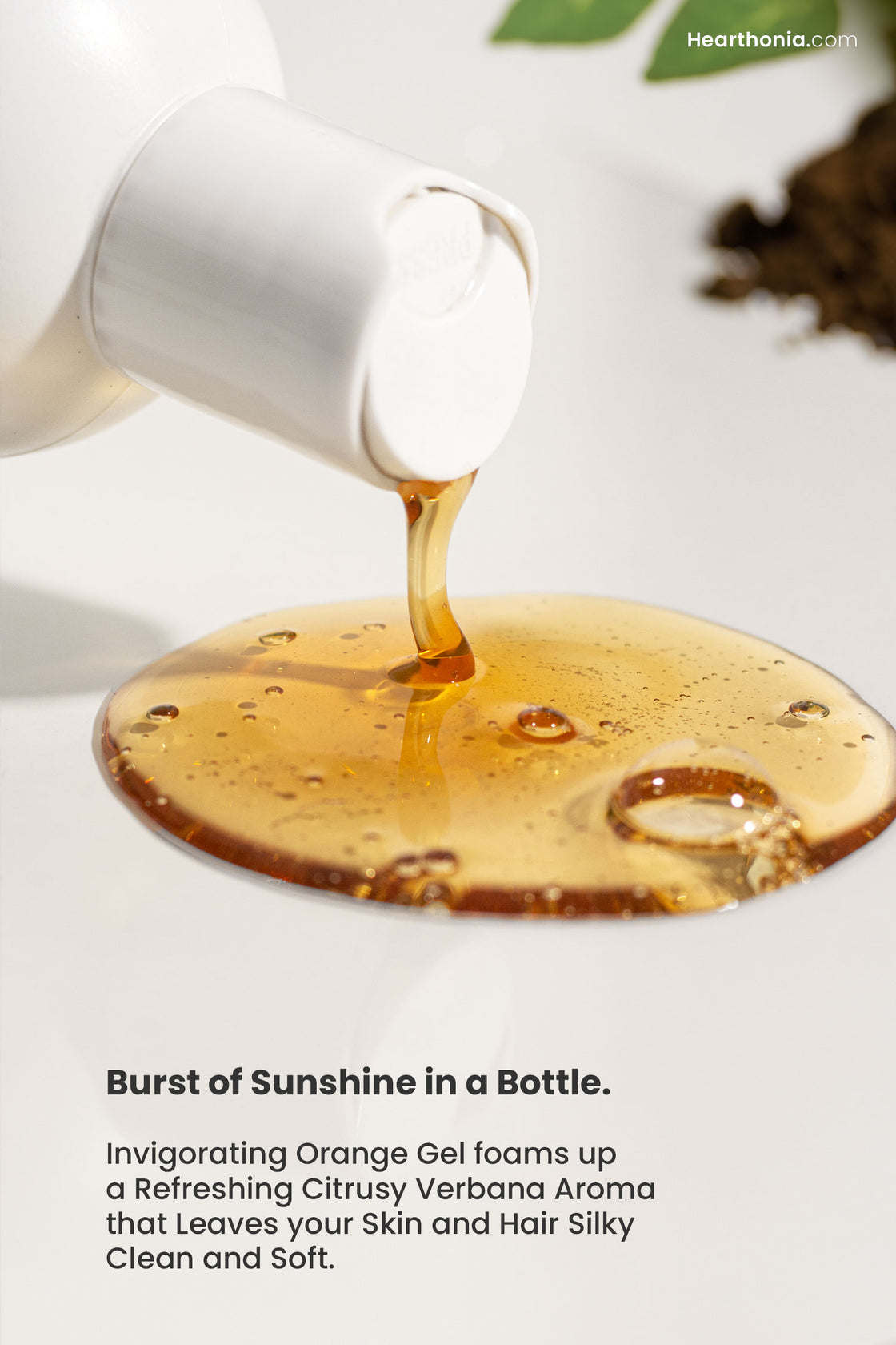 Druide organic hair and body wash   
dispensed from its white bottle on to a clean surface showcasing its sunshine orange glow with text reading "burst of sunshine in a bottle".